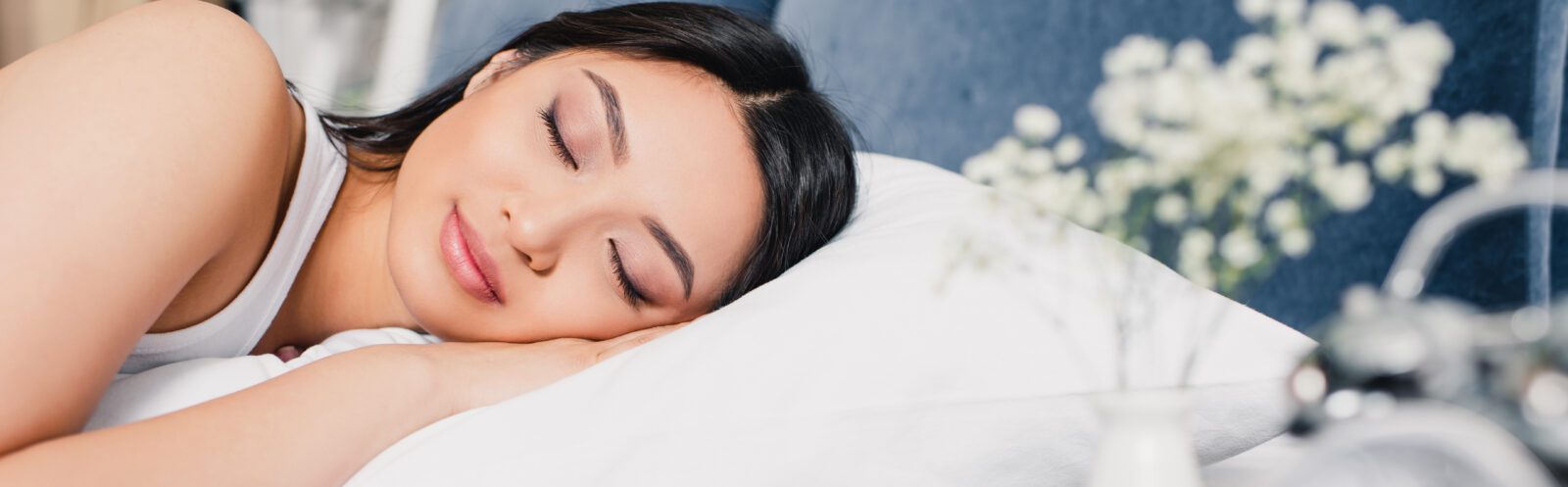 Panoramic shot of beautiful asian woman sleeping on bed at home