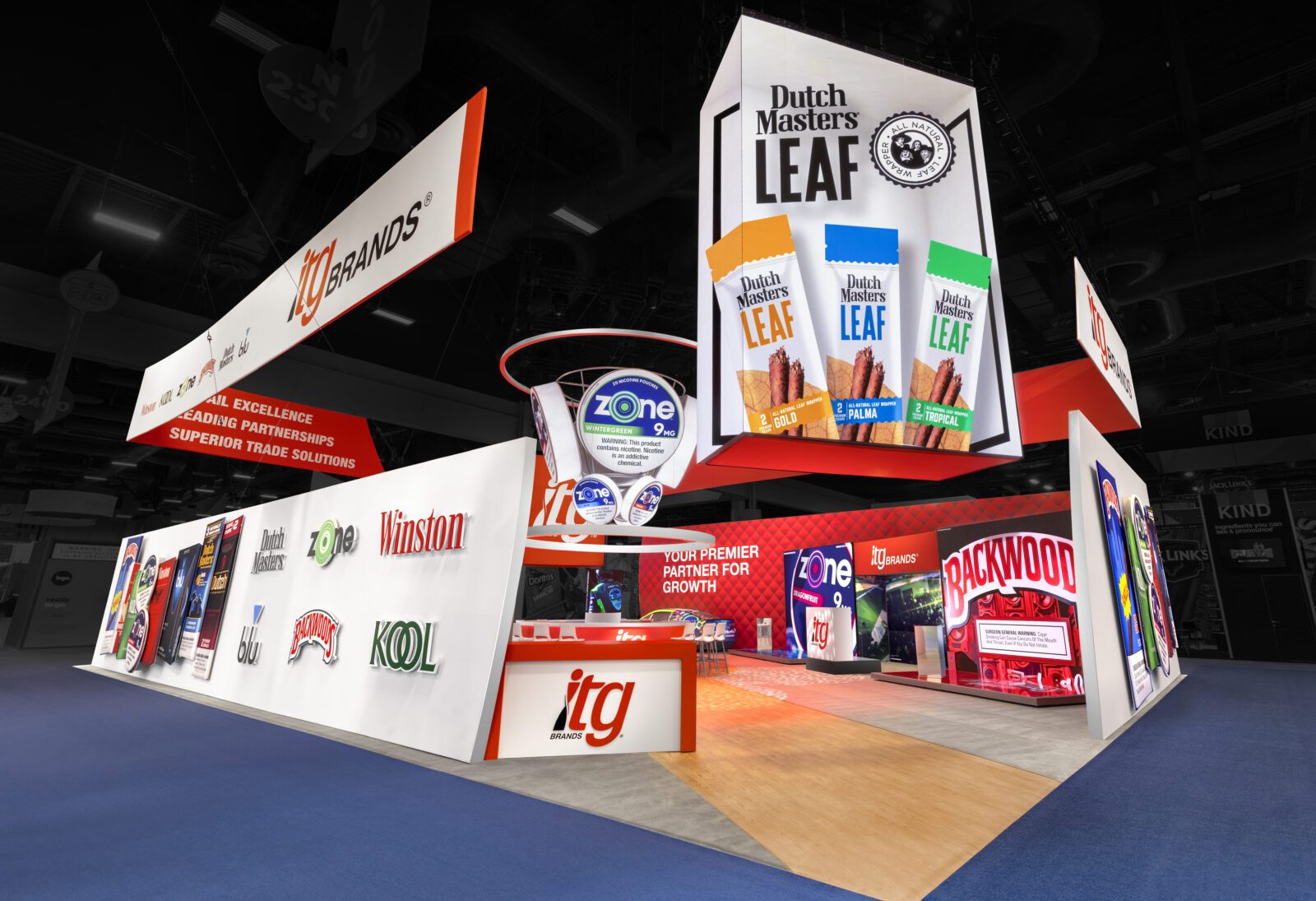 Trade show booth featuring ITG Brands with displays of tobacco product logos, Dutch Masters Leaf packaging, and promotional signage for trade solutions and partnership.