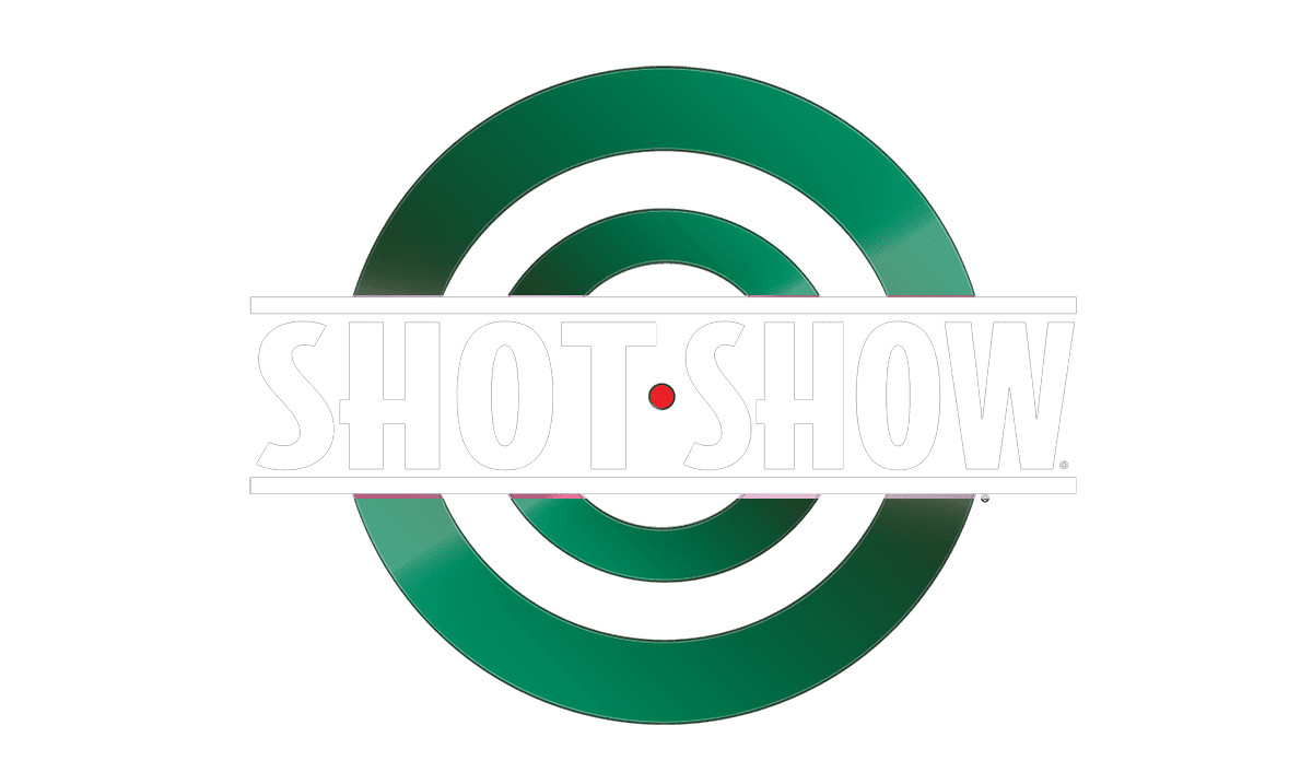 Green target graphic with the words "SHOT SHOW" in bold white letters across the center and a small red dot in the middle of the target.